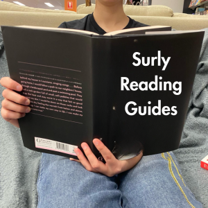 Person reading a book on a couch. The book cover reads "Surly Reading Guides"